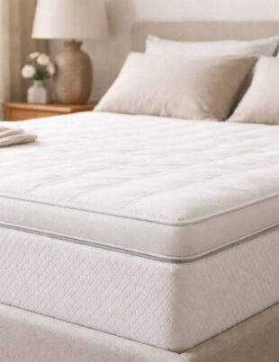 Mattress topper placed on bed for back pain support in a modern bedroom
